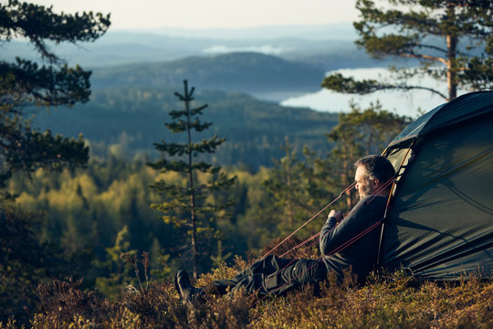 Man sitting in front of tent