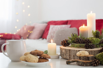 cup of tea with burning candles on white table