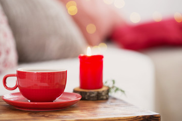 cup of tea with burning candles at home