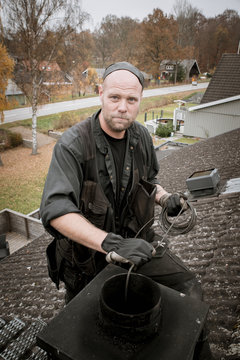 Chimney sweep on roof