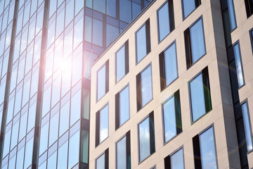 Modern office building detail, glass surface with sunlight. Business background. 