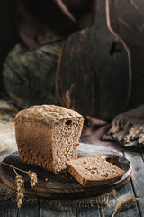 The sourdough bread without yeast in the cut on a wooden Board on a dark background