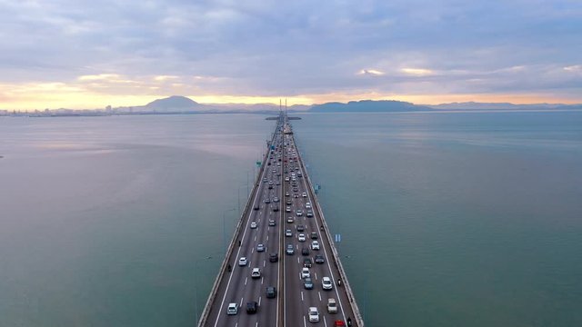Aerial dramatic sunrise view with traffic at first Penang Bridge, Malaysia. 