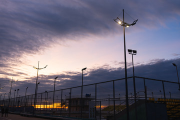 Beautiful sunset on the promenade of Batumi, Georgia. Lanterns illuminate the promenade