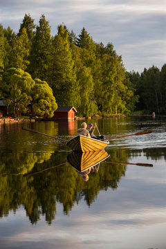 People rowing on lake