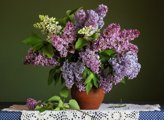 branches of white and purple lilac in a vase