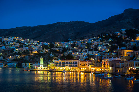 Illuminated town at sea, Symi, Greece