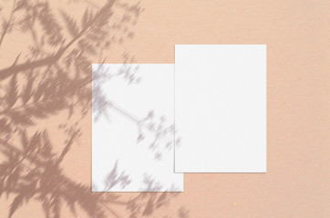 Blank white vertical paper sheet 5x7 inches with shadow overlay. Modern and stylish greeting card or wedding invitation mock up.