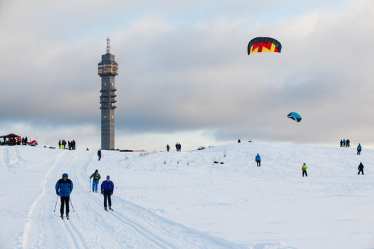 People skiing and paragliding at winter, Gardet, Stockholm, Sweden