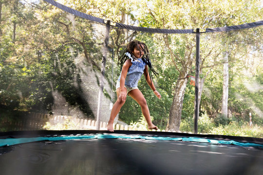 Girl jumping on trampoline