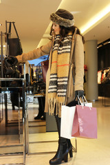 Elegant young woman enjoys shopping