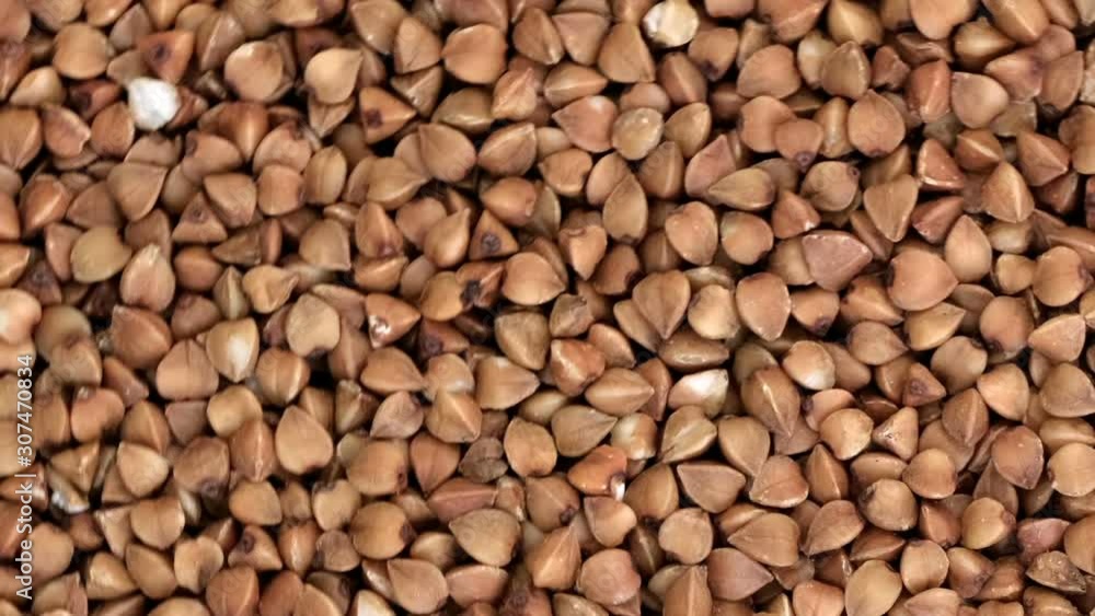 Poster grocery video screen saver, rotating buckwheat background closeup top view using zoom and move the c