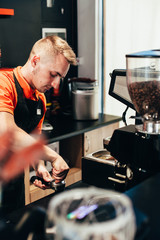 Barista makes delicious coffee in a coffee shop