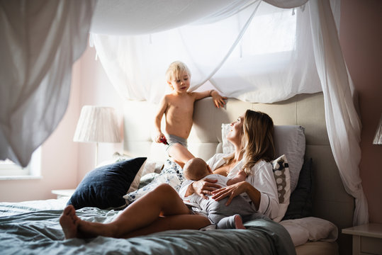 Mother lying in bed with sons
