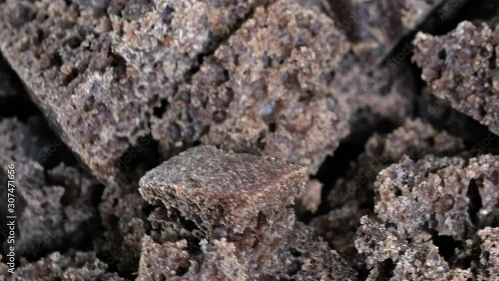 Poster grocery video screensaver, rotating background from small pieces of black rye bread macro close-up t