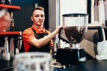 Barista makes delicious coffee in a coffee shop