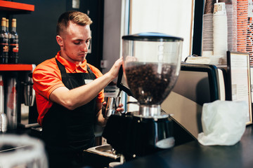 Barista makes delicious coffee in a coffee shop