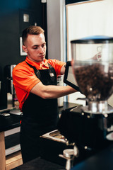 Barista makes delicious coffee in a coffee shop