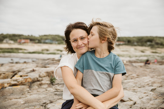 Mother and son kissing at seaside