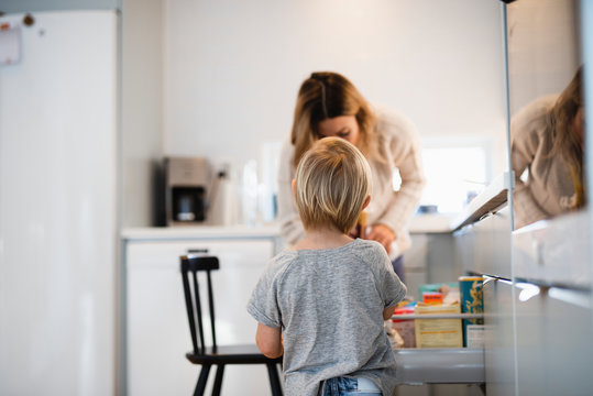 Boy with mother in kitchen