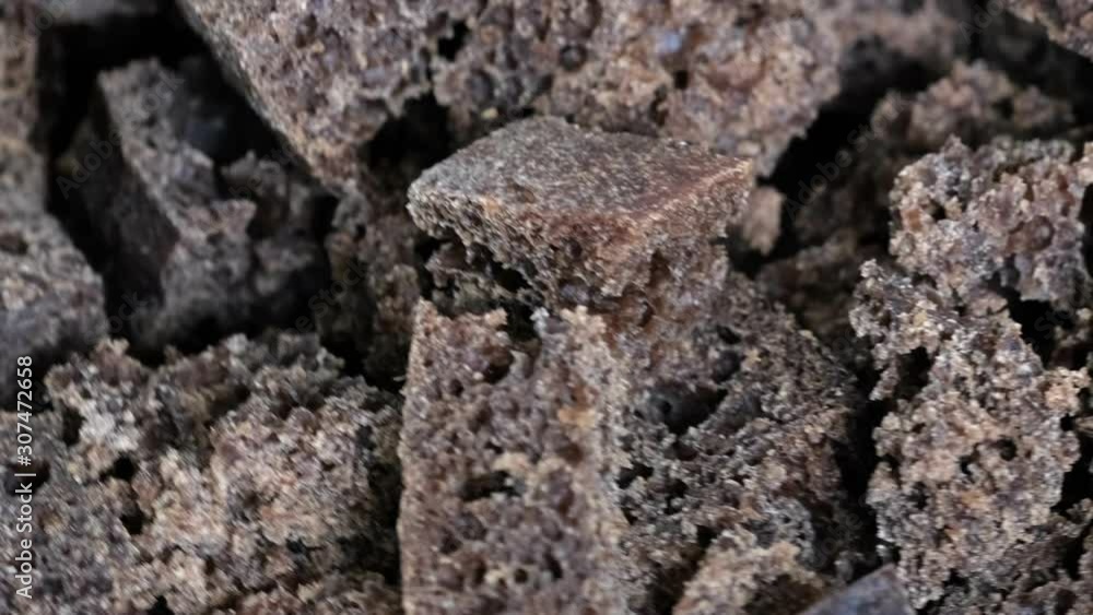 Poster grocery video screensaver, rotating background from small pieces of black rye bread macro close-up t