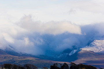 Beautiful view of the Snowdonia Mountain range and stunning cloud formations rolling between the peaks