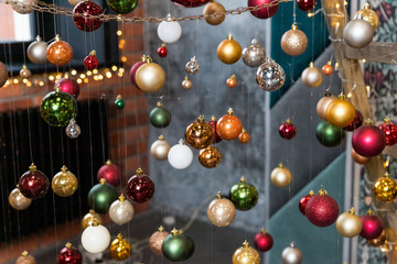 Creative festive composition with string on blurred background.Winter concept. Christmas tree decorations, colorful balls.Christmas baubles.Cafe, Restaurant,Street decorations.Happy new year