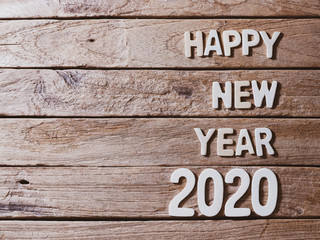 happy new year 2020 alphabet on old wood background