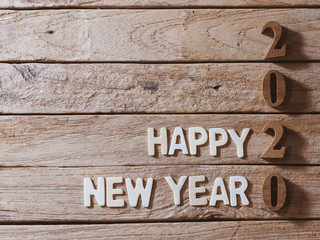 happy new year 2020 alphabet on old wood background