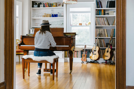 Stylish Teen Girl Playing Piano at Home