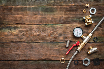 Plumbing flat lay background with copy space. Pipeline equipment on plumber workbench.