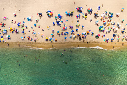 Fototapeta Aerial view of people at public beach Spiaggia di Cala Sinzias, Cagliari, Italy.