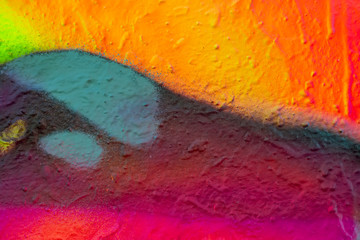 Beautiful bright colorful street art graffiti background. Abstract creative spray drawing fashion colors on the walls of the city. Urban Culture, pink, red, orange, , green, crimson, purple texture