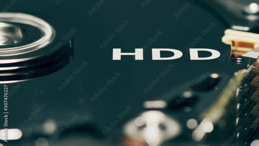Poster moving head of computer hard disk drive reveals hdd text