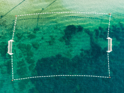 Aerial view of water polo field at transparent water, Sumartin, Croatia.