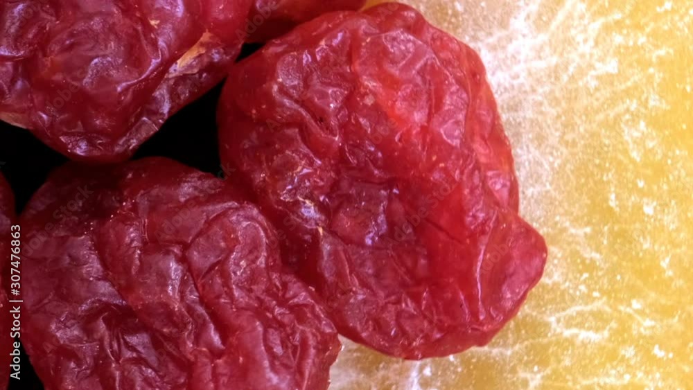 Poster grocery video screen saver, rotating background of dried slices of mango and cranberry macro close-u
