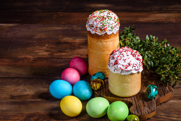 Easter cake and colorful eggs on a dark background