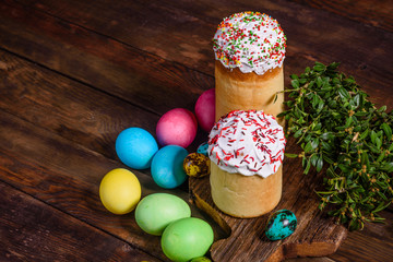 Easter cake and colorful eggs on a dark background