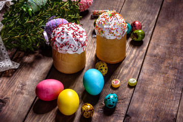 Easter cake and colorful eggs on a dark background