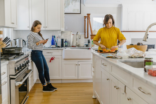 Mother and Daughter Talking In Kitchen