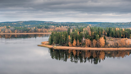View from the top of the Snake Mountain on Lake Ladoga and a stone island with a forest, Skhera, near the town of Lahdenpohja in Karelia, Russia, in the autumn day