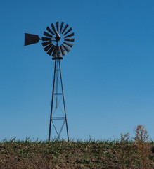 Metal windmill in farm country