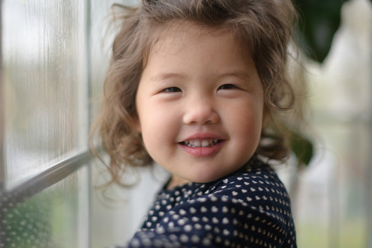 Toddler smiling by window