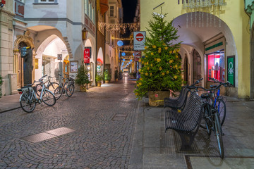 Bolzano, Italy 01 December 2019: Christmas decor on the night streets of Bolzano in South Tyrol.