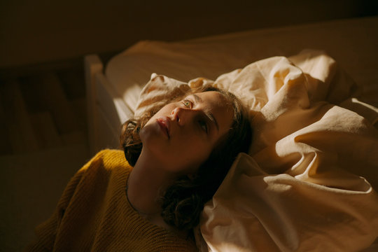 Atmospheric Portrait Of A Girl On The Couch In Beautiful Light