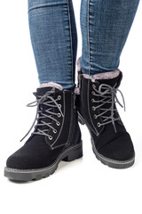 demi-season women's boots black on the feet in jeans on a white background
