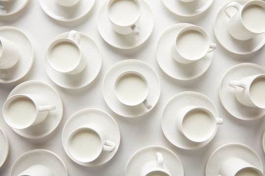 Layout of white cups with milk