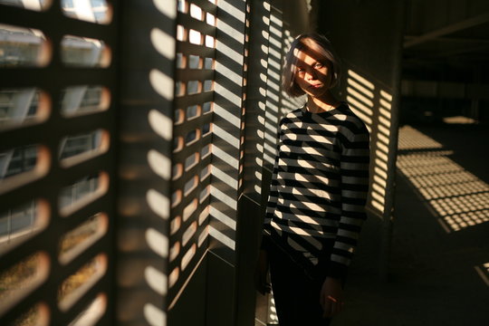 portrait of a girl in a light shadow figure and a striped sweater