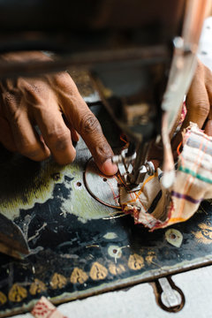 Crop ethnic sewer making ornamental bag