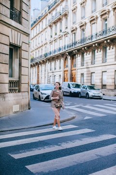 Pretty woman cross the street in Paris